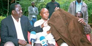 ODM party leader Raila Odinga alongside former Mungiki leader Maina Njenga.