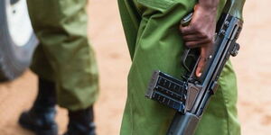 A Kenyan police officer holding a gun 