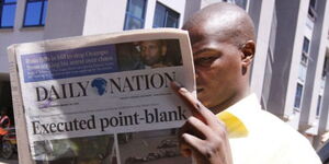 A Kenyan reading the Daily Nation newspaper