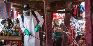 An official from the Ministry of Health disinfects a section of Gikomba market in Nairobi on March 22, 2020.
