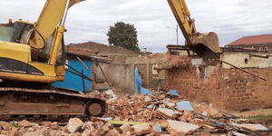 A bulldozer demolishes the home of the mother of former nominated MP Catherine Nyamato on Saturday, May 23, 2020, in Nyamira.