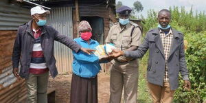 A family receiving donations from officers in Kiambu County on Thursday, June 11