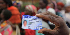 A hand holding a National Hospital Insurance Fund card