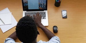 A man pictured while working on his personal computer.