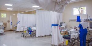 A nurse and a patient pictured in a ward at the Garissa Referral Hospital.