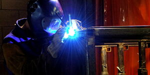 A person welding a door