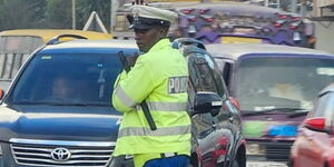 A photo of a traffic officer controlling traffic along Ngong Road, Nairobi