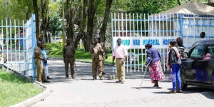 A photo of kanjos and residents standing outside the War Memorial Hospital in Nakuru County