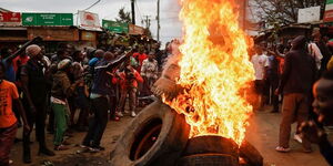 A photo of protestors burning tyres during a past demonstration