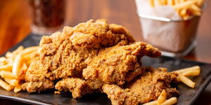 A plate of fried chicken and fries
