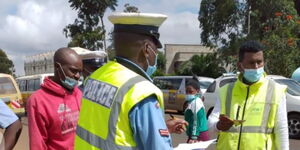 A police officer engages a motorist during the NTSA crackdown on Tuesday, May 4, 2021.