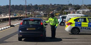 A police officer stops a motorist for inspection in Jersey