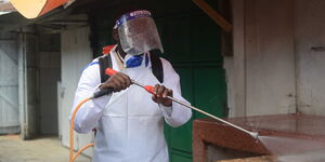 A public health officer fumigating Burma market in Nairobi on 25th March 2020