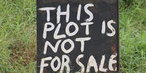 A sign post showing that the land is not for sale