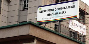 A signpost showing the Department of Immigration Headquarters in Zimbabwe