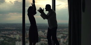 A silhouette of a couple arguing.