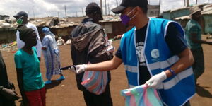 A social worker distributing face masks in Nairobi.