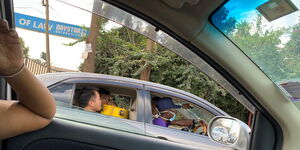 A taxi operator pictured driving while donning a face mask.
