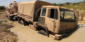 A truck stuck in mud on a road