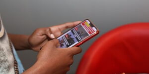 A user browsing through a smartphone for news.