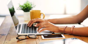 A woman using a laptop to study