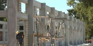 A worker leans on an incomplete building at the fruit processing under construction in Kwale County