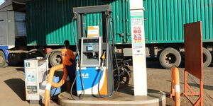 AN Image of  A Fuel Station Attendat Awaiting for the next Vehicle, at Ola Energy in Ruiru. Dated March 20.