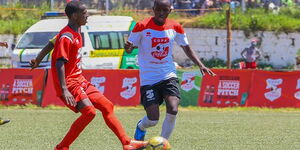 Abdulrahman Miraji of Serani Boys High School (left) challenges Chrispus Namenge of Koyonza Boys in the Copa Coca Cola Under 16 boys' final at Moi Stadium in Kisumu on August 3, 2019.