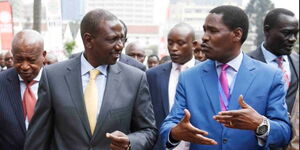 Agriculture CS Peter Munya (L) and Deputy President William Ruto (R) engage in a conversation in a past event.