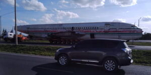 An airplane's fuselage being transported at a highway in Kenya.