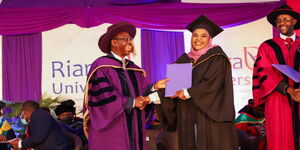 Riara University Chancellor Dr Wilfred Kiboro presents a conferment and excellence award to Aisha Mbarak, Class of 2022 overall top student graduating with First Class Honours in Bachelor of Communication and Multimedia Journalism at the institution’s 6th Commencement on Friday, July 8, 2022.