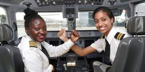 An Image of Two Pilots in an Aeroplane Cockpit.