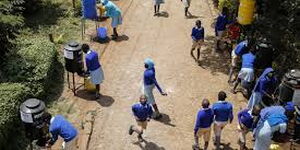 An aerial view of pupils at a school sanitizing at various stations set up as per the Ministry Of Health regulations.