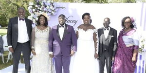 An image of Stacey Kositany and Sam Kilomo (center) and their parents in their white wedding on Saturday, March 19. .jpg