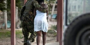 An image of a KDF officer rescuing a student during the Garissa University attack in 2015.