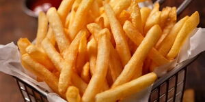 An image of chips being served at a fast food restaurant.