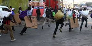 An image of traders running from county askaris