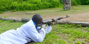 An officer from the DCI Forensics division test-fires a gun