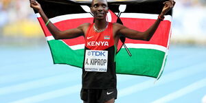 Asbel Kiprop poses with the Kenyan flag after winning the 1500m at the 2013 World Athletics Championships in Moscow, Russia
