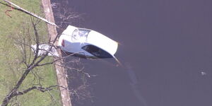Australian police pull a car that plunged into a Lake out of the water.