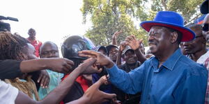 Azimio La Umoja Coalition party leader Raila Odinga interacting with boda boda riders in the Nairobi CBD Wednesday, October 12, 2022