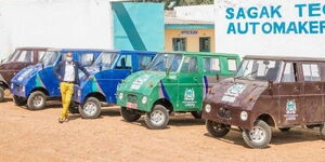 Samwel Njogu posing for a photo in front of the BJ 50 vehicles in Laikipia County.