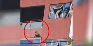 Kenyans trying to save a baby who climbed out of the window on the 4th floor of a building in Kisii County