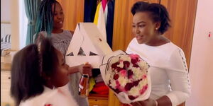 Media celebrity Betty Kyalo receives a cake and flowers for her birthday on March 14, 2021