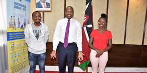 Brain Orinda (left), Health Cabinet Secretary Mutahi Kagwe (centre) Brenda Cherotich (right) posing for a photo at Afya House on April Wednesday 1, 2020.