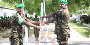 Brigadier Jeff Nyagah (left) taking over from Brigadier Paul Njema (right) at AMISOM Sector II Headquarters in Dhobley in February 2021..