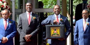 Treasury CS Ukur Yattani (with briefcase) poses for a photo with his docket's officials before reading the Budget 2020/21 in Parliament on Thursday, June 11, 2020