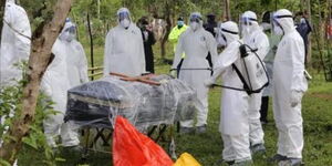 Bungoma county health workers in PPEs move Tony Waswa's (Brother to Bungoma Senator Moses Wetangula) casket to his final resting place on Wednesday, May 20.