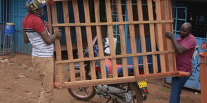 Buyers load a second-hand bed onto a motorbike at Witeithie area, Kiambu county. June 10, 2020.