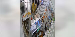 A screengrab of CCTV footage showing thugs storming into a shop armed with a AK-47 on February 26, 2023.